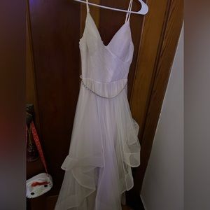 Cream colored, flowy prom gown with a shiny rhinestone belt